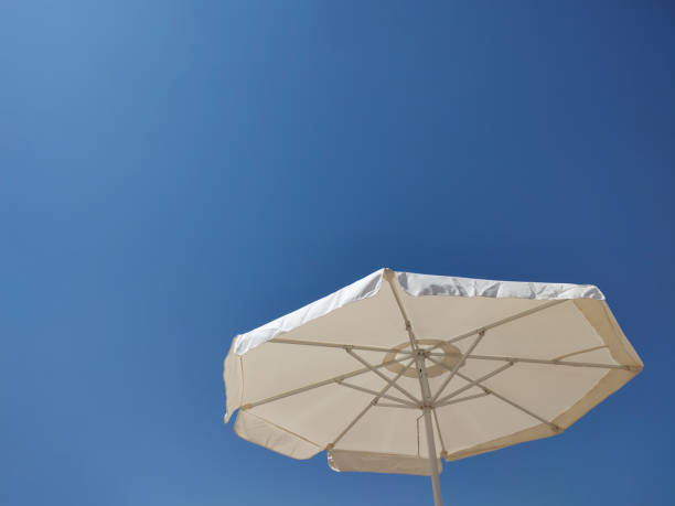 Sun umbrella against clear blue sky