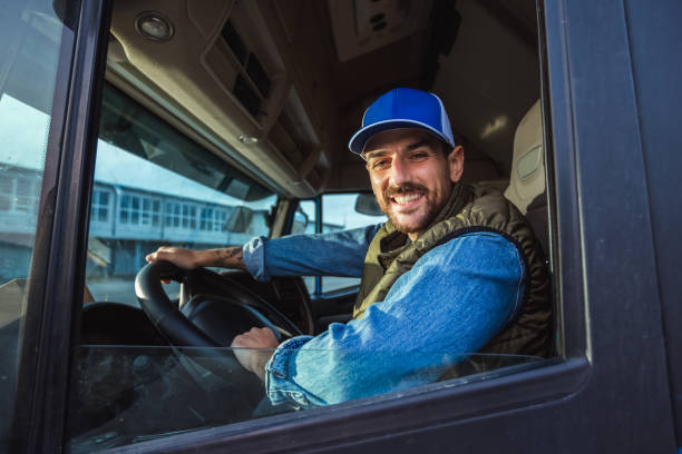 istock Young handsome truck driver driving a truck. 2154189862