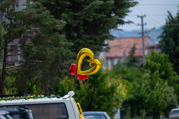 Red bow tied on a white car door handle. Traditional Chinese wedding concept.