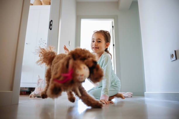 istock Little girl playing with dog at corridor 2154190085