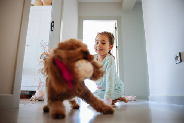 istock Little girl playing with dog at corridor 2154190238
