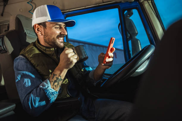 istock Young handsome man working in towing service and drinking coffee so he could get some energy. Talking on the phone. 2154190429