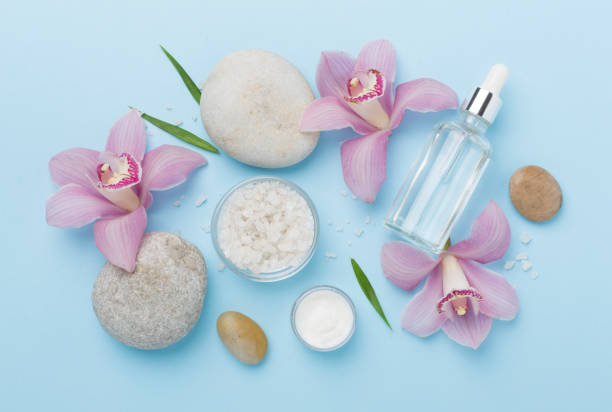 istock Composition with orchids and massage stones on color background, top view 2154191421