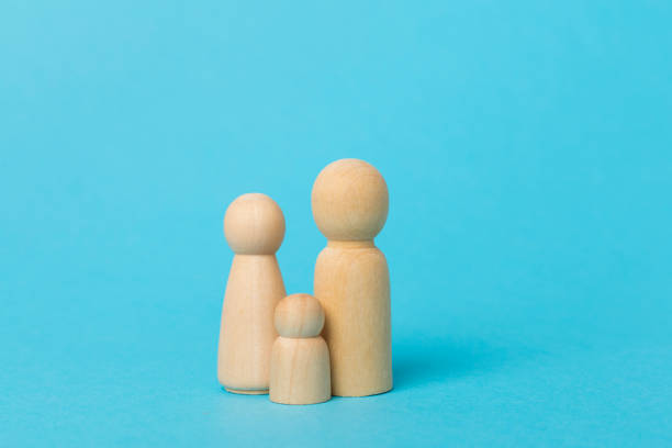 istock Wooden family figures on color background 2154191848