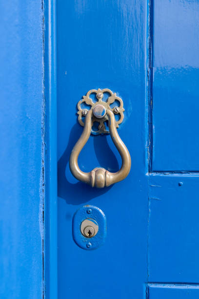 istock Brass knocker on a blue painted door. 2154193820