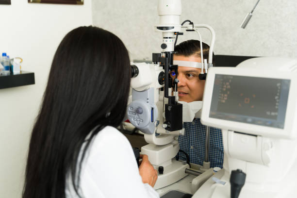 istock Qualified ophthalmologist conducts an eye examination on a man using advanced diagnostic tools in a clinical environment 2154195389