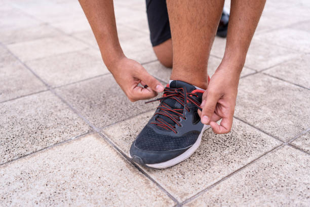 Man tying his shoe for exercise