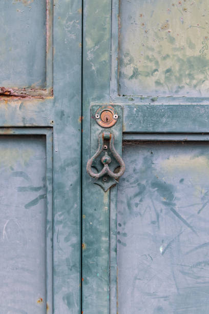 istock Rusted knocker on an old faded door. 2154198036