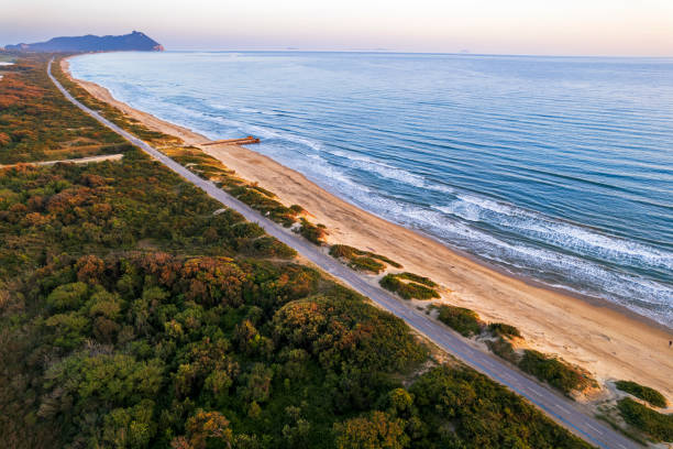 istock Empty road stretching on sand dunes facing the sea, Sabaudia, Italy 2154199608
