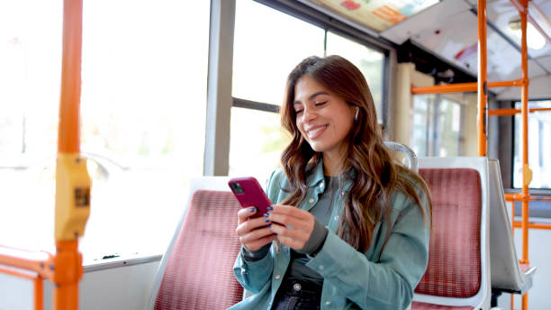 istock Happy Latin woman using smartphone in the bus 2154199943