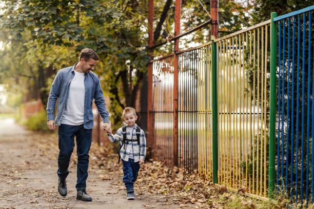 istock A father and kindergartener holding hands and going to school. 2154202506