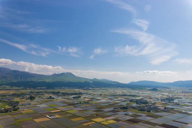 it is Scenery of Aso in Kumamoto Prefecture and rice fields from a hill