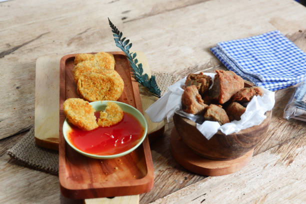 istock chicken nugget food on a board 2154205360