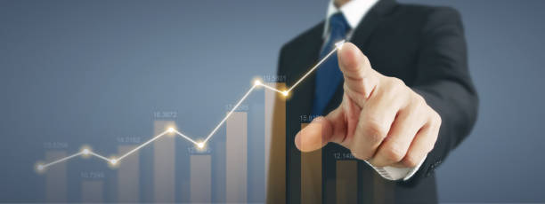 istock Businessman with chart financial symbols coming from hand 2154205579