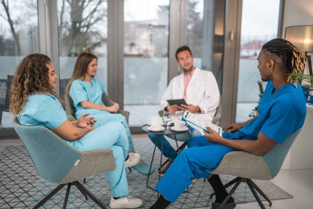 istock Diverse Medical Team in Discussion at Doctor's Office 2154211638