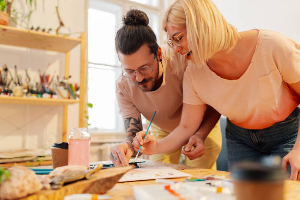 istock Young happy hipster couple painting at creative art studio. 2154211944