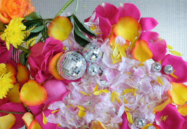 Disco Balls on Pink, Orange and yellow rose petals with peony petals, overhead shot