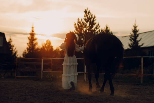 istock Woman with her horse at outdoors ranch 2154212985