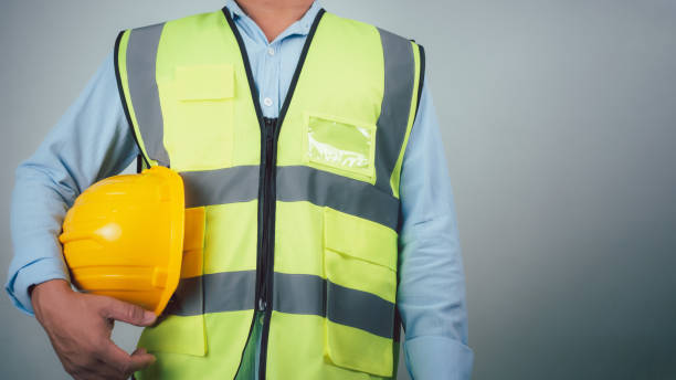 istock Civil engineer architect standing holding a safety helmet on grey background, Construction site plans to build high-rise buildings, Engineer building concept, Background for construction. 2154214585