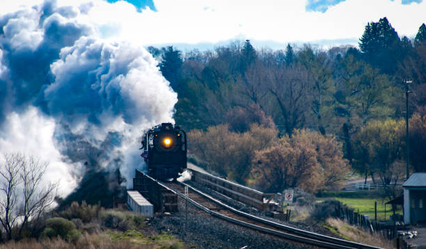 Aylsham, Norfolk, United Kingdom: October 15, 2024: ‘Mark Timothy’, a narrow gauge railway steam engine approaching the turntable at Aylsham railway station. The 15'' Bure Valley Railway runs between Aylsham and Wroxham in Norfolk, Eastern England; it uses steam, electric and diesel engines and stops at Brampton, Buxton and Coltishall on its way to Wroxham in the heart of the Norfolk Broads. The Bure Valley Railway opened in 1990 and has been a popular tourist attraction ever since.