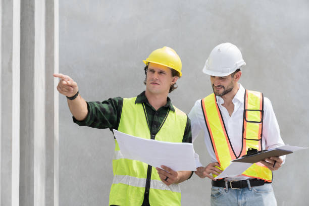 istock Team of male engineer construction working and inspecting structure of building at construction site. Two male construction builder working at construction site 2154219282