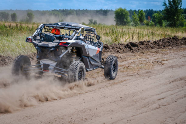 istock UTV buggy, ATV (quad), 4x4 in the action on sand 2154219998