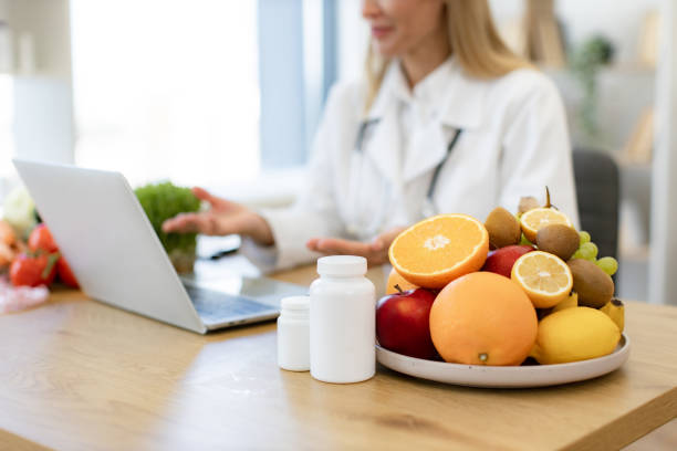 istock Cropped view of female making video call at wireless device at doctors workplace 2154220276