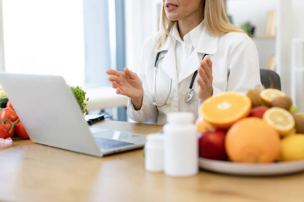 istock Cropped view of female making video call at wireless device at doctors workplace 2154220282