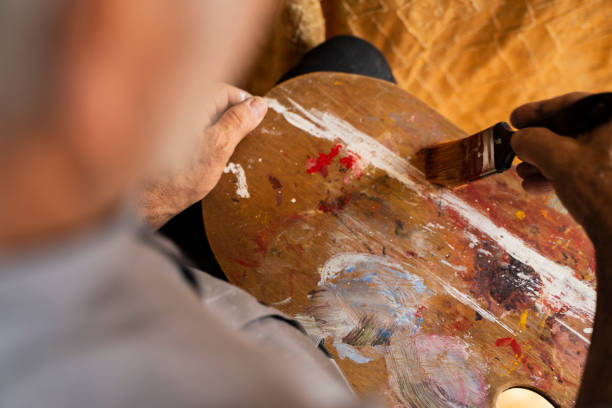 istock Painter prepares the colors on his palette 2154226300