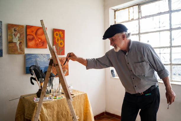istock Man creates art on canvas with his paintbrush 2154226517