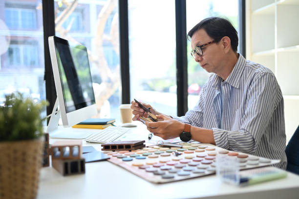 istock Experienced senior interior designer working on project in modern office 2154234451