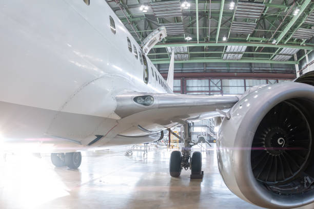 istock White passenger airplane in the aviation hangar. Plane under maintenance 2154235434