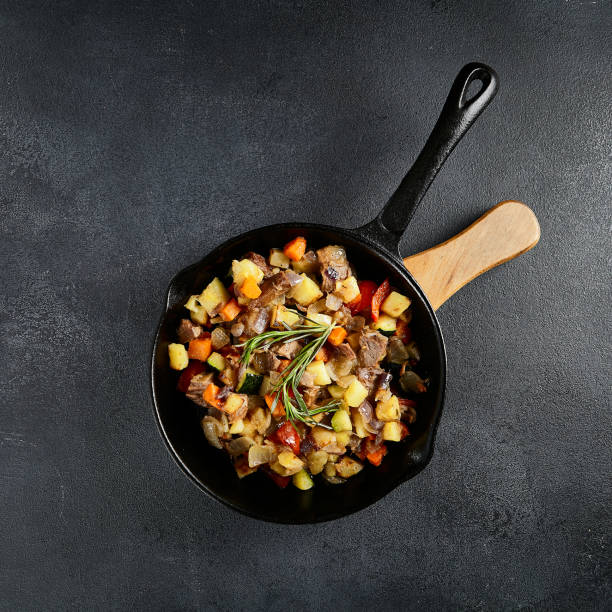 istock Top view of a hearty skillet beef ragout with mixed vegetables on a textured black backdrop 2154235821