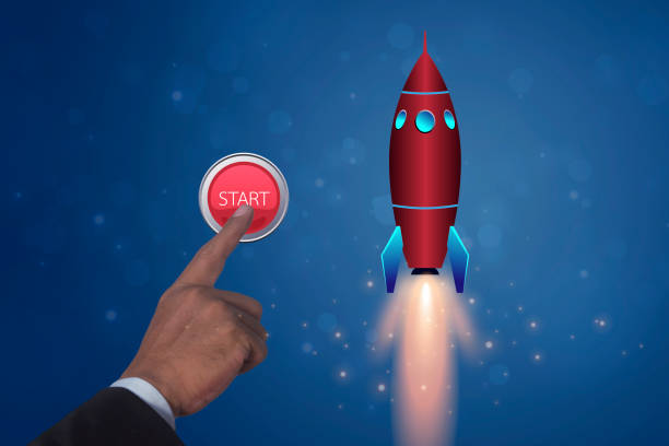 Businessman hand presses the big red start rocket launch button. Corporate business, Start up and launch concept.