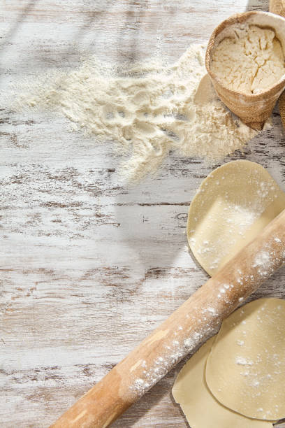 istock Baking in a Rustic Kitchen: Flour, Rolling Pin, and Dough Preparation on Wooden Table 2154236449