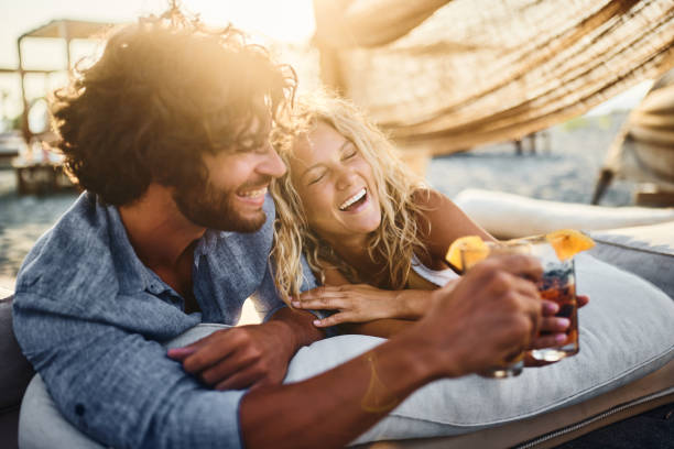 istock Happy couple in love toasting on a beach bed. 2154238554