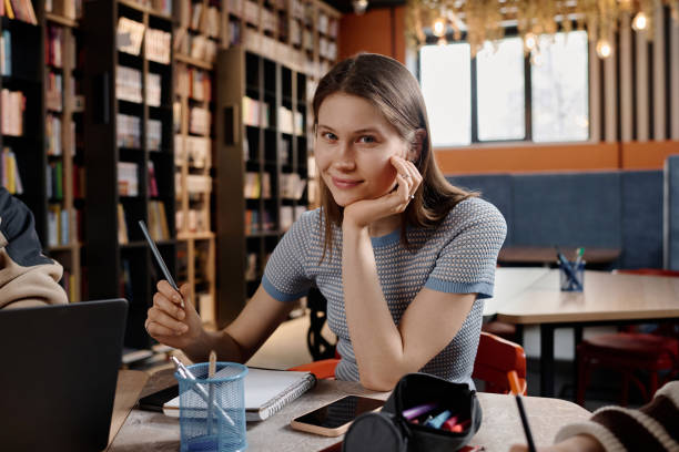 istock Caucasian Girl Sitting At Table In Library 2154240127