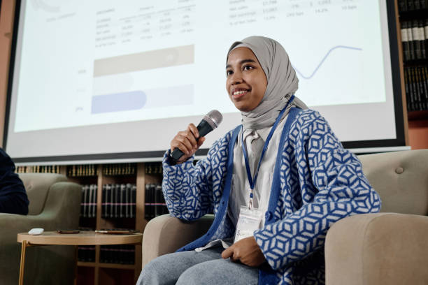 istock Muslim Girl Speaking At Conference 2154240691