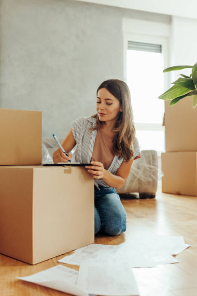 istock Young woman drawing in her new apartment 2154241427