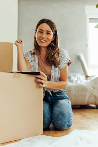 istock Pretty woman smiling while moving in 2154241429