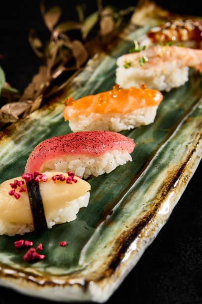 istock Diverse Sushi Selection with Salmon, Tuna, Shrimp, Eel, Scallop on a Sleek Plate 2154241719
