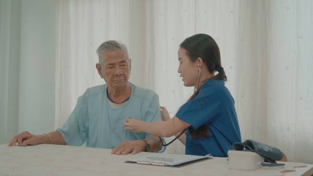 istock Woman therapist nurse taking care senior elderly man. 2154242174