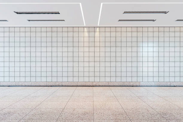 istock Empty subway station with a clean tiled wall and floor, modern ceiling lights, concept of public transportation space. 3D Rendering 2154242279
