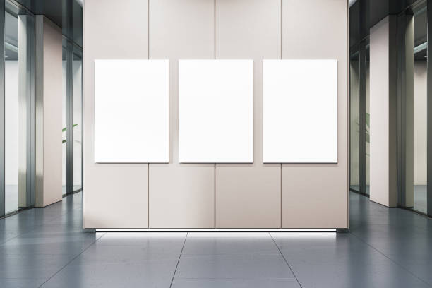 istock A modern corridor with three blank white posters on a wall, suitable for branding mockups, with a reflective floor and panels. 3D Rendering 2154242333