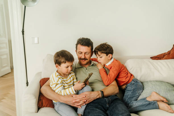 istock Father with his sons at home 2154242495