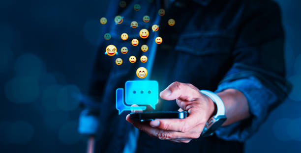 istock A man is holding a cell phone with a blue screen that has a bunch of smile face 2154242602