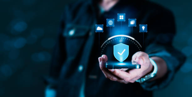 istock A person is holding a cell phone with a blue shield on it 2154242607