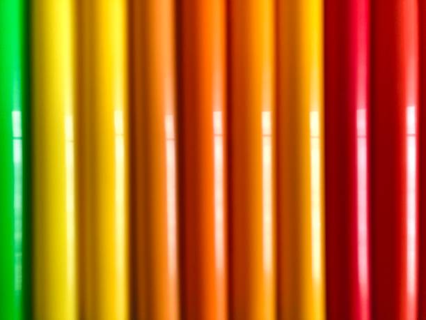 defocused, blurred background of colorful rows of rods\tof colored pencil