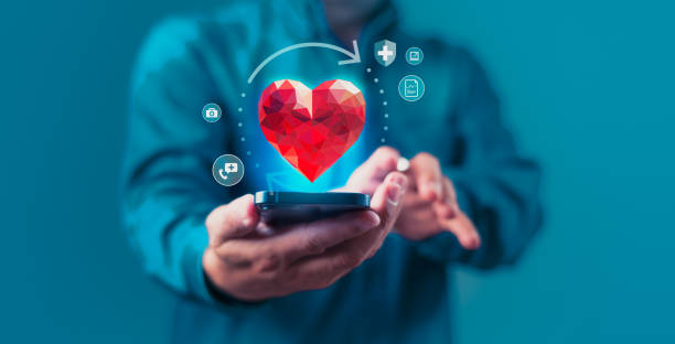 istock A man holding a cell phone with a red heart shape on it 2154243488