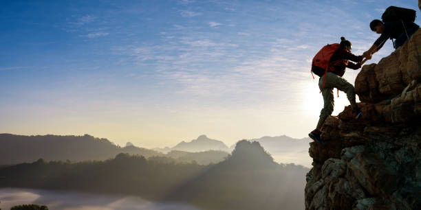 istock Asian hiking help each other on mountains 2154243819